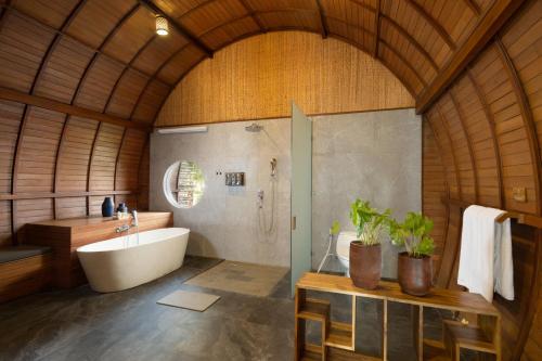 a large bathroom with a tub and a sink at Beehouse Dijiwa Ubud in Ubud