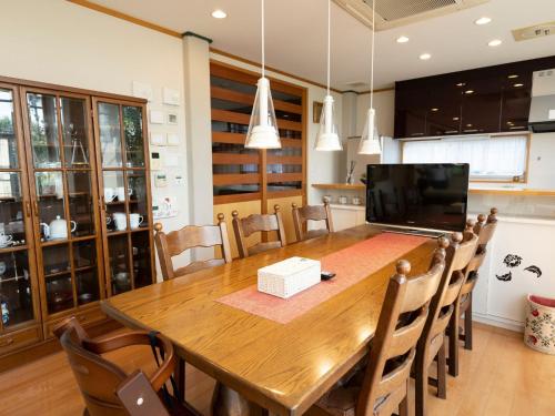 a kitchen and dining room with a wooden table and chairs at Palm Villa - Vacation STAY 12202 in Takamatsu