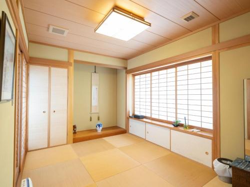 an empty room with a large window in a room at Palm Villa - Vacation STAY 12202 in Takamatsu