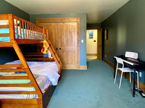 a bedroom with a bunk bed and a piano at Cajun Cabin Private Nature Resort in Minden