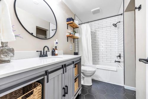 a bathroom with a sink and a mirror at Newly renovated-across the street from Von Stiehl! in Algoma