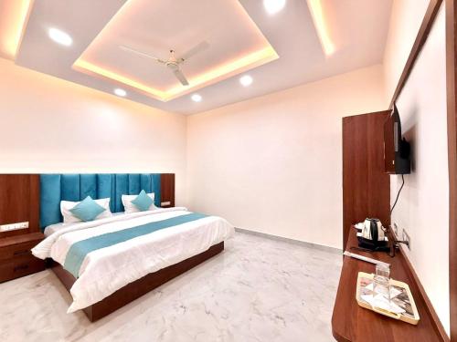 a bedroom with a bed and a television in it at Hotel Betwa sarowar in Orchha