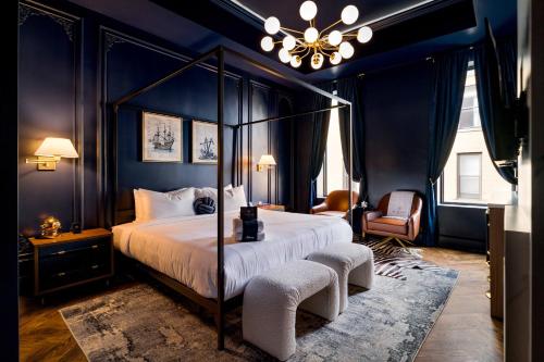 ein Schlafzimmer mit Himmelbett und Kronleuchter in der Unterkunft The Highliner Hotel in Gloucester