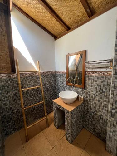 a bathroom with a sink and a mirror at Follow The Rabbit Bungalow in Gili Islands