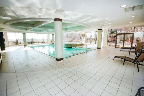 a large swimming pool in a building with a pool at PlanURstay - Ideal 2 BR & 2BTH 3888 Duke of York Blvd in Mississauga