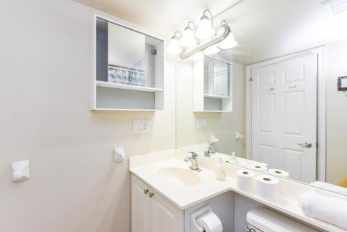 a white bathroom with a sink and a mirror at PlanURstay - Ideal 2 BR & 2BTH 3888 Duke of York Blvd in Mississauga