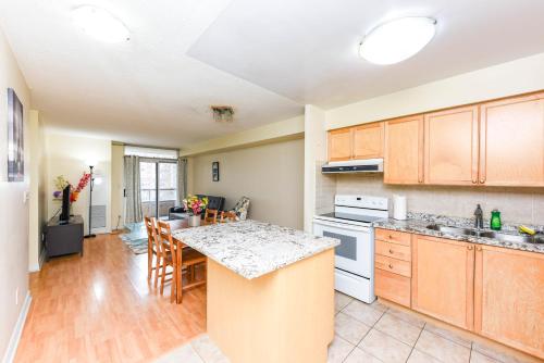 a kitchen with wooden cabinets and a counter top at PlanURstay - Ideal 2 BR & 2BTH 3888 Duke of York Blvd in Mississauga