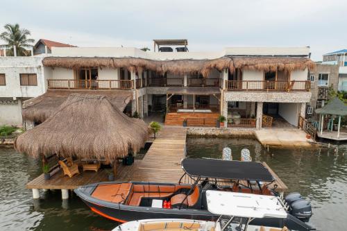 a boat on the water in front of a building at Casa Barú in Barú