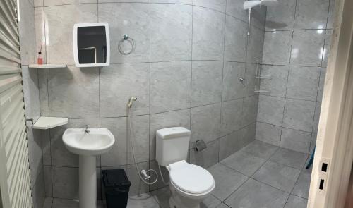 a bathroom with a toilet and a sink at Pousada e Cachoeira Paraiso in Barra do Garças