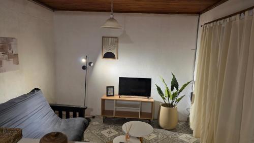 a living room with a couch and a computer on a desk at Departamento dos dormitorios en 3er piso por escaleras in Chajarí