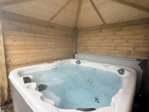 a jacuzzi tub in a wooden room at The Farm House in Skipton