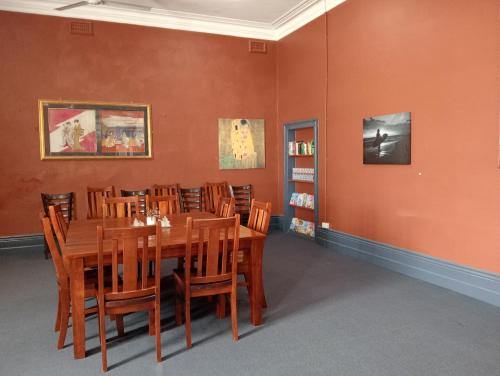 a dining room with a wooden table and chairs at Australia Hotel Fremantle in Fremantle