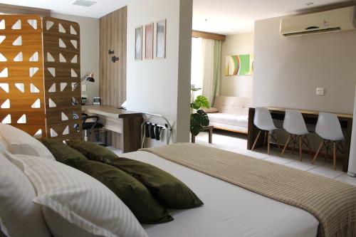 a bedroom with two beds and a desk and a room at ApartHotel - Nobile Suites Monumental Brasília in Brasília