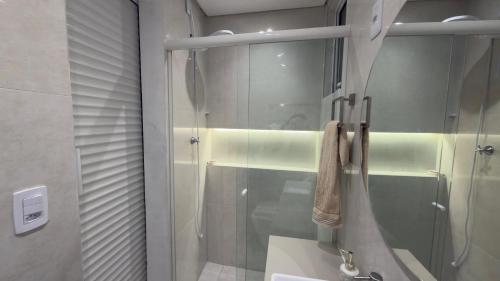 a bathroom with a shower with a glass door at Conchas Lofty in Governador Celso Ramos