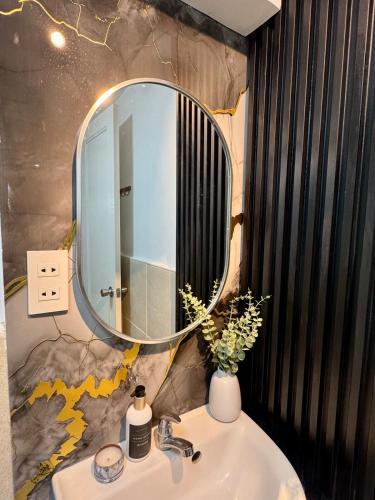 a bathroom with a sink with a mirror on the wall at Skyline Abode Antipolo in Antipolo