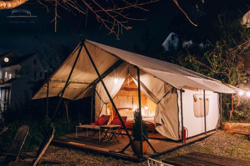 a tent with a bed and a chair in it at The LOOP Boutique Hotel & Café in Da Lat