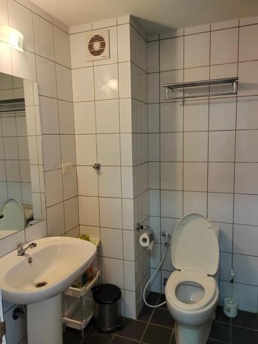 a bathroom with a toilet and a sink at AvataraA B32 by malai in Ban Tha Fat