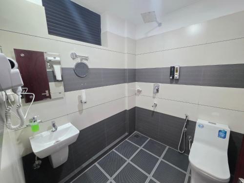 a bathroom with a sink and a toilet at Dreamwagon hotel lakkidi in Vythiri