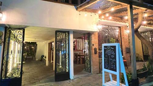 a restaurant with a sign in front of a building at Hostal Mago in Tlaxcala de Xicohténcatl