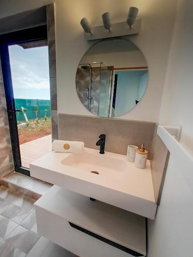 a bathroom with a sink and a mirror at Sagar Réunion in Saint-Paul