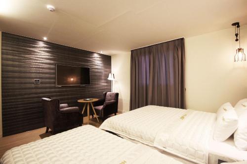Postel nebo postele na pokoji v ubytování MU Hotel