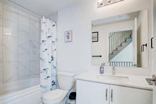a bathroom with a toilet and a sink and a shower at Downsview Park Luxury Townhome near Yorkdale Transit in Toronto