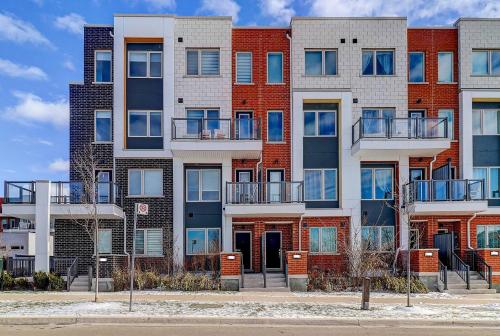 an apartment building with balconies on a city street at Downsview Park Luxury Townhome near Yorkdale Transit in Toronto