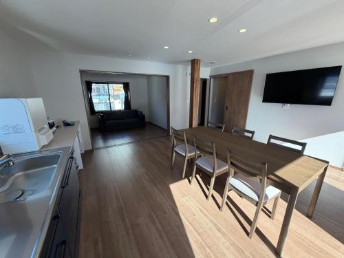 a kitchen and dining room with a table and chairs at あづまや野沢温泉 in Nozawa Onsen