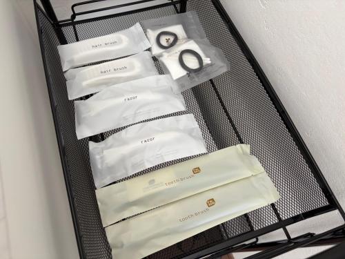 a black wire shelf with three white products on it at あづまや野沢温泉 in Nozawa Onsen