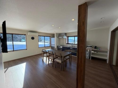 a kitchen and dining room with a table and chairs at あづまや野沢温泉 in Nozawa Onsen