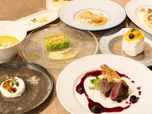 a bunch of plates of food on a table at Nature Base Hotel NUPPUKOTTE in Teshikaga