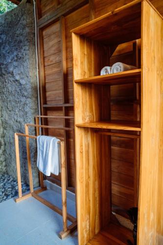 a room with a sauna with wooden walls and shelves at Kubu Cemara Sidemen in Karangasem