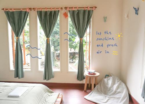 a bedroom with a bed and a window with curtains at MiTS in Bandung