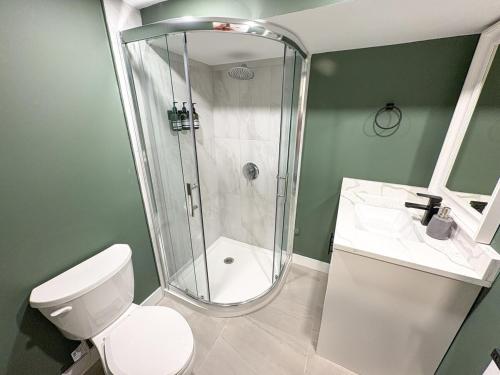 a bathroom with a shower and a toilet and a sink at Vancouver UBC 3BD Garden Suite in Vancouver