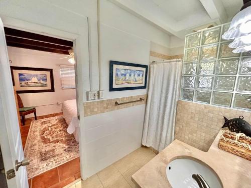 a bathroom with a sink and a shower at Baked and Barefoot Beach Bunglows in St. George Island