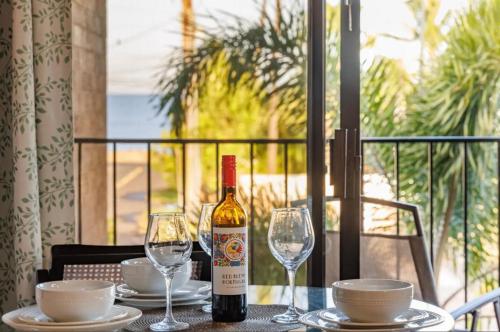 a bottle of wine sitting on a table with glasses at Best Deal and Epic Location 2bd 2BA Ocean View in Kihei