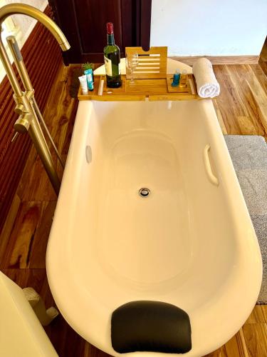 a bathroom with a toilet with a table on top of it at Nicholas Cottage in Nuwara Eliya