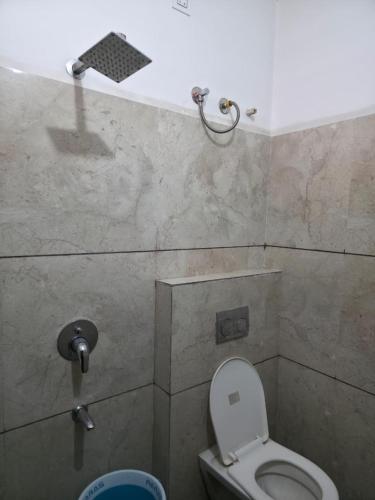 a bathroom with a toilet and a shower at Hotel Right Choice in Indore