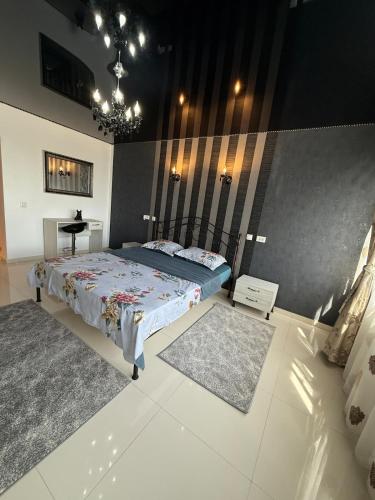 a bedroom with a bed and a table in it at Apartment Saturn in Galaţi