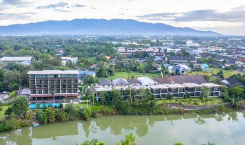 an aerial view of a resort next to a river at Riverawan Hotel in Chanthaburi