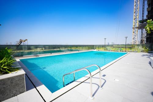 a swimming pool on the roof of a building at Samaya Holiday Homes - Cloud Stylish Suites with Balcony in Dubai