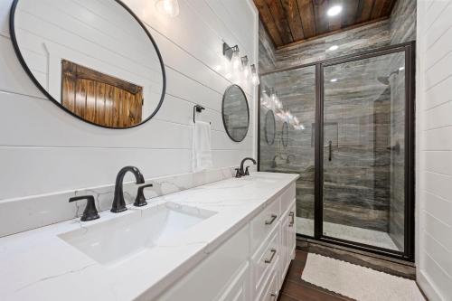 a bathroom with a sink and a mirror at Spa Game Room Sunset Views 5BR Cabin in Broken Bow