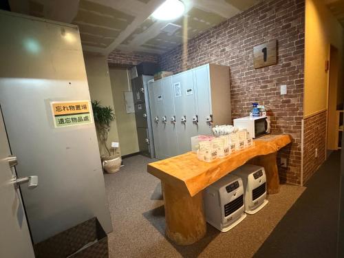 a kitchen with a counter and a refrigerator in a room at 湯沢粉雪の宿 in Yuzawa
