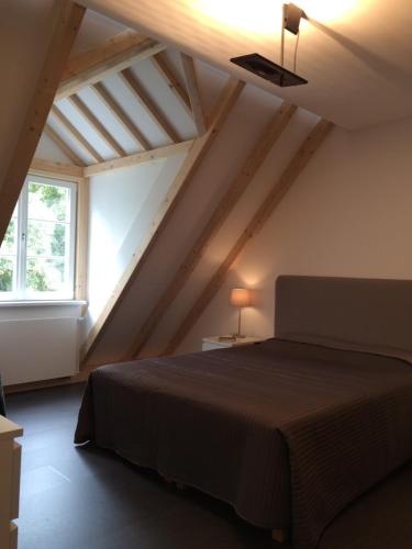 a bedroom with a bed in a attic at Apartment Adlerhorst in Homburg