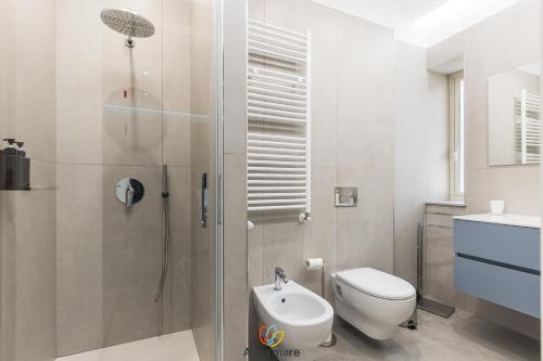 a bathroom with a shower and a toilet and a sink at Alma Mare in Crotone