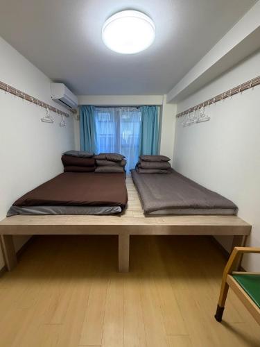 two beds sitting on a table in a room at Kinjiro Hotel in Tokyo