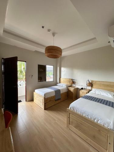 a bedroom with two beds and a large window at Olana Bed and Breakfast in Labrador