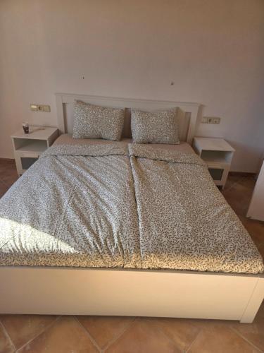 a bed in a bedroom with two night stands at Sa Torreta in Algaida
