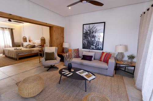 a living room with a couch and a table at Casa del Mar - Luxury Seaside Villa in Boca de la Vinorama