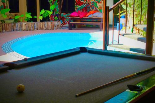 a pool table in front of a swimming pool at Chillin' House in Cat Ba